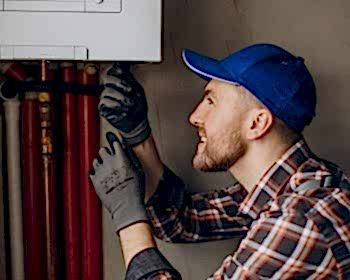 service-man-adjusting-house-heating-system_1303-26529