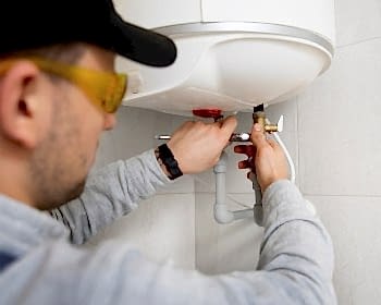 worker-repairing-water-heater_23-2149334231