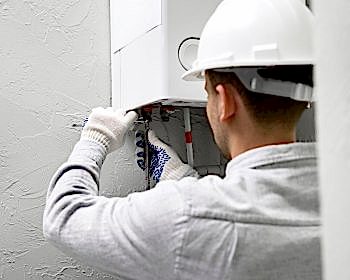 worker-repairing-water-heater_23-2149334232